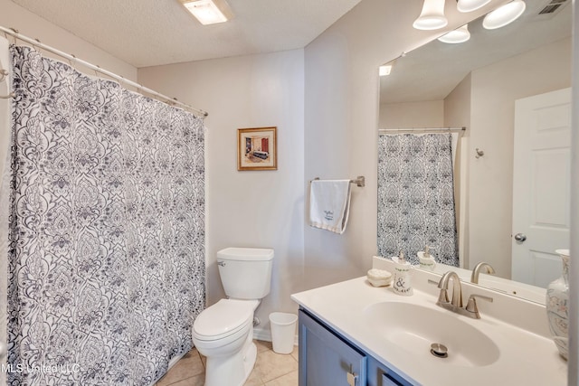 bathroom with tile patterned floors, vanity, toilet, and a textured ceiling