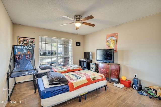 bedroom featuring a textured ceiling and ceiling fan