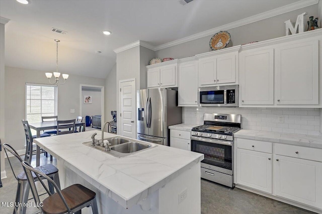 946 Filmore Dr, Brandon, MS 39042 - kitchen featuring appliances with stainless steel finishes, a chandelier, decorative backsplash, white cabinets, and recessed lighting