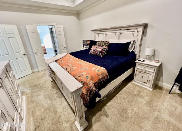 bedroom featuring crown molding and light colored carpet