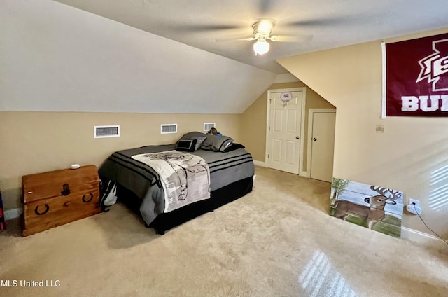 carpeted bedroom with vaulted ceiling and ceiling fan