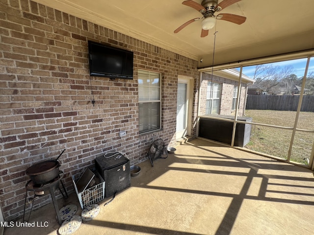 unfurnished sunroom featuring ceiling fan