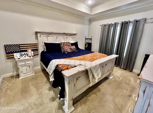 bedroom featuring light colored carpet, crown molding, and a raised ceiling