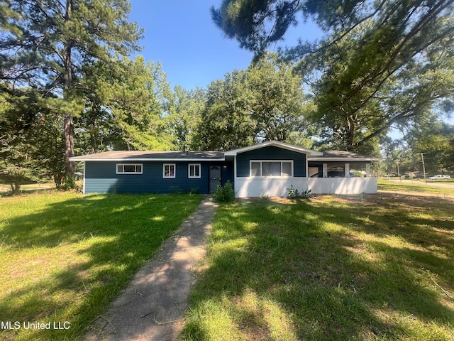 ranch-style home with a front lawn