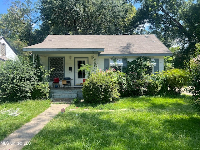 view of front of home with a porch and a front lawn