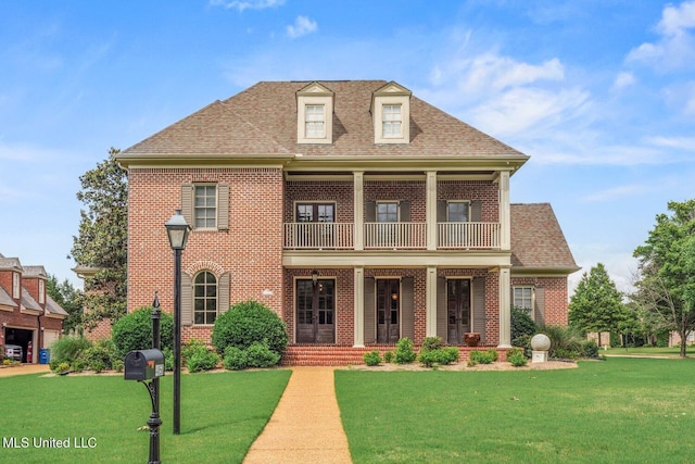4050 Robinson Xing, Olive Branch, MS 38654 - view of front of property featuring brick siding, a balcony, a front lawn, and roof with shingles