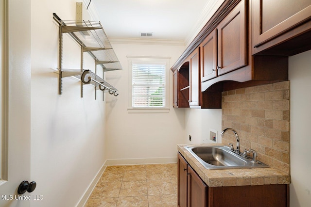 4050 Robinson Xing, Olive Branch, MS 38654 - laundry room with hookup for an electric dryer, crown molding, washer hookup, baseboards, and cabinet space