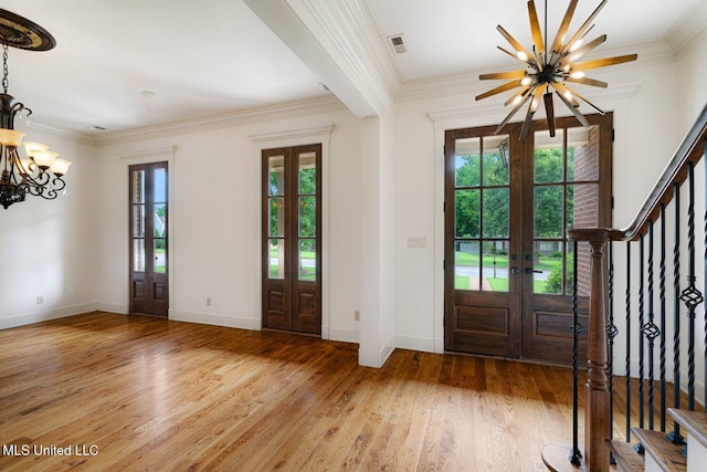 4050 Robinson Xing, Olive Branch, MS 38654 - entrance foyer with french doors, a chandelier, stairs, light wood finished floors, and crown molding