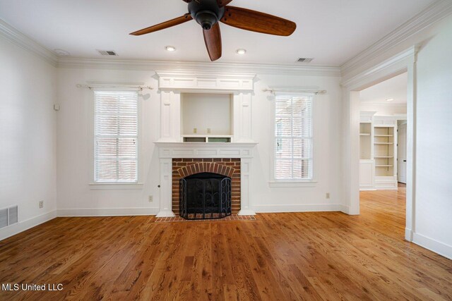 4050 Robinson Xing, Olive Branch, MS 38654 - unfurnished living room featuring crown molding, baseboards, a fireplace, ceiling fan, and plenty of natural light