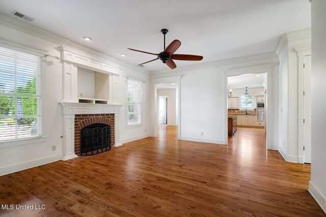 4050 Robinson Xing, Olive Branch, MS 38654 - unfurnished living room featuring ornamental molding, baseboards, a ceiling fan, a fireplace, and recessed lighting