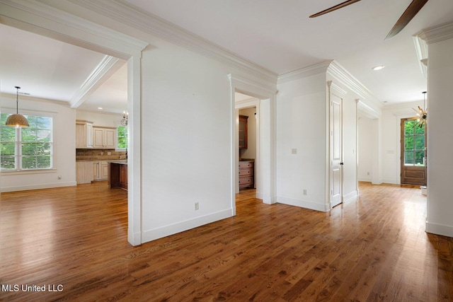 4050 Robinson Xing, Olive Branch, MS 38654 - unfurnished living room with baseboards, healthy amount of natural light, light wood-type flooring, ornamental molding, and recessed lighting