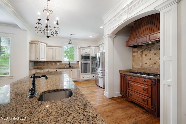 4050 Robinson Xing, Olive Branch, MS 38654 - kitchen with appliances with stainless steel finishes, a sink, backsplash, ornamental molding, and light wood finished floors