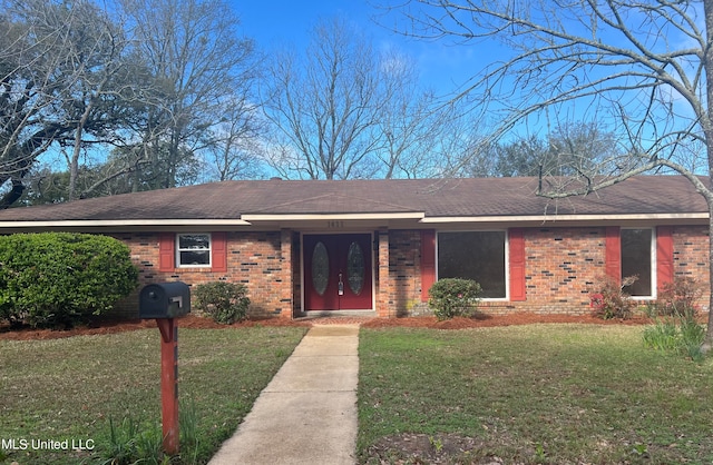 ranch-style home with a front yard