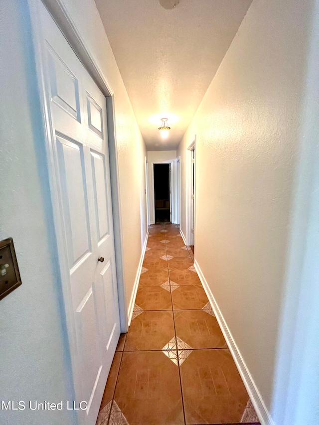 hallway featuring tile patterned flooring