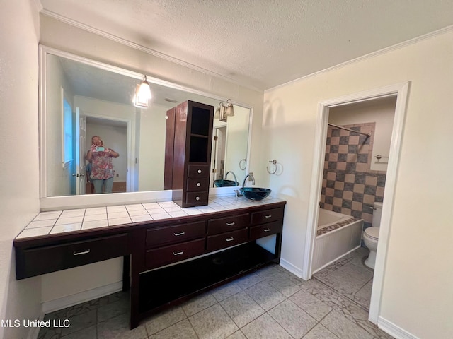 full bathroom featuring toilet, ornamental molding, vanity, a textured ceiling, and shower / bathtub combination with curtain