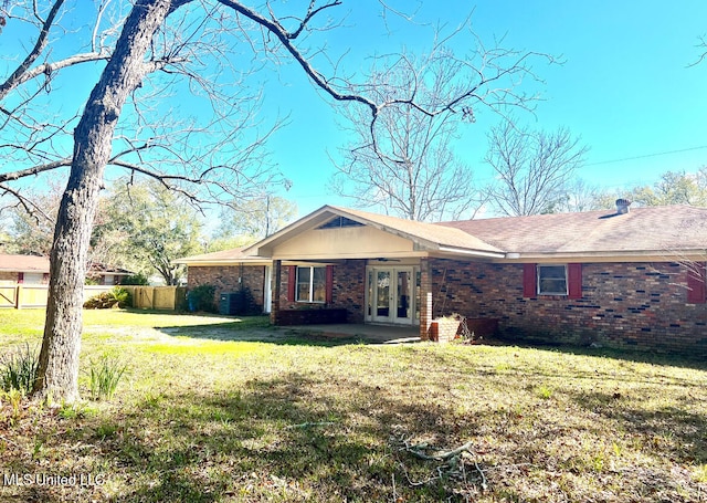 single story home with french doors and a front yard