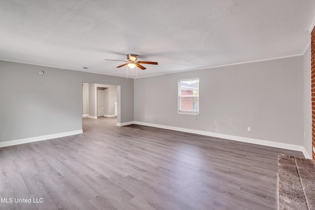 empty room with crown molding, hardwood / wood-style floors, and a textured ceiling