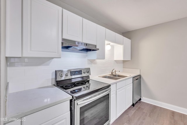 kitchen with sink, light hardwood / wood-style floors, white cabinets, and appliances with stainless steel finishes