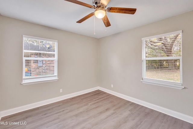 empty room featuring ceiling fan, a healthy amount of sunlight, and light hardwood / wood-style floors