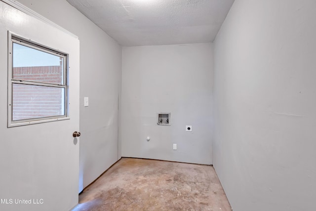 laundry area with hookup for an electric dryer, hookup for a washing machine, and a textured ceiling