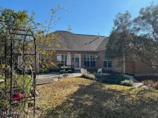 back of property with a patio