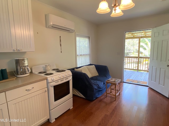 kitchen featuring white cabinets, hanging light fixtures, dark hardwood / wood-style flooring, an AC wall unit, and white range oven