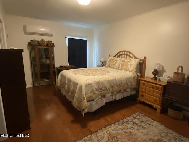 bedroom with wood finished floors and an AC wall unit