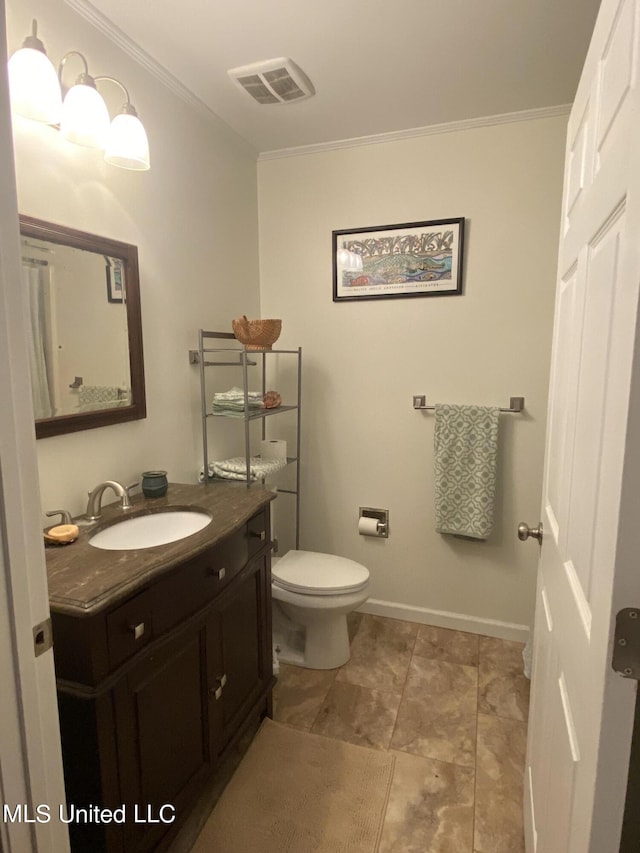 bathroom featuring toilet, vanity, baseboards, visible vents, and crown molding