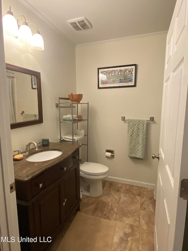 bathroom with vanity, toilet, and crown molding