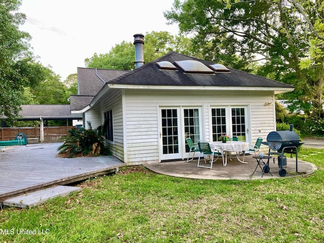 back of house with a patio area, a deck, and a lawn