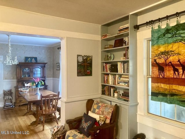 sitting room with crown molding and hardwood / wood-style flooring