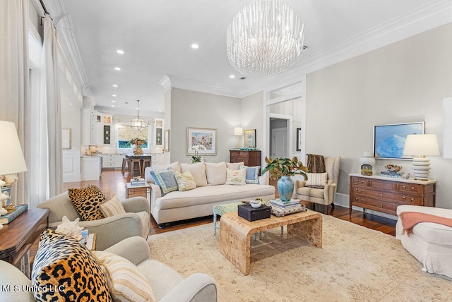 living room with crown molding, a notable chandelier, and hardwood / wood-style flooring