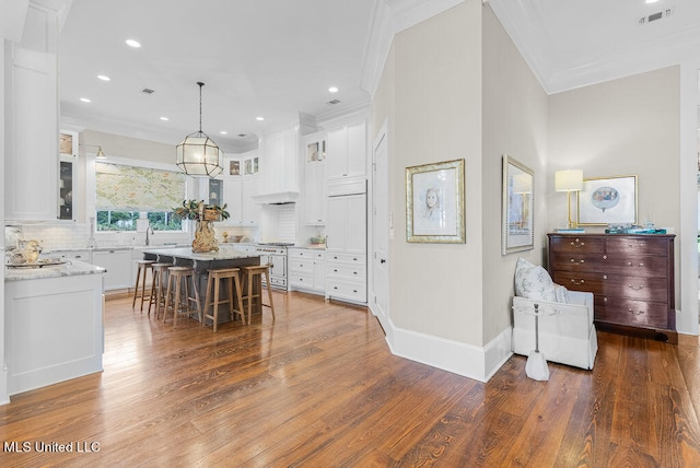 kitchen with white cabinets, a center island, and dark hardwood / wood-style floors