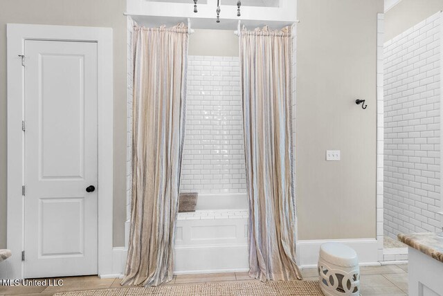 bathroom featuring tile patterned floors and shower / bathtub combination with curtain