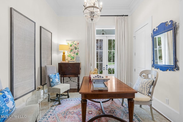 sitting room featuring crown molding, wood-type flooring, and a chandelier