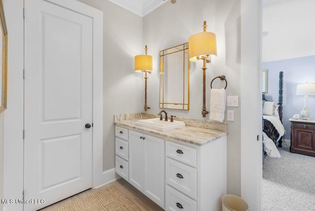 bathroom with vanity and ornamental molding