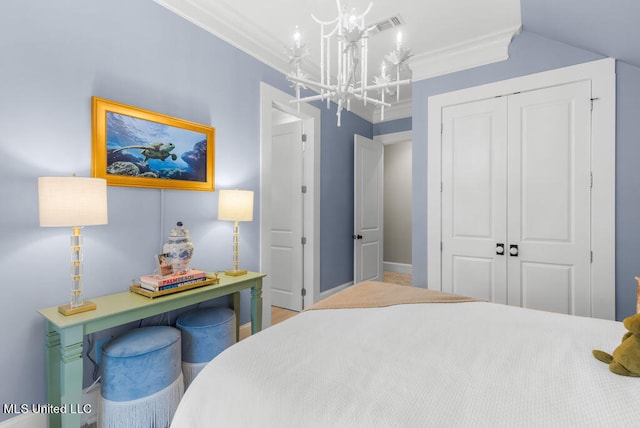 bedroom with a closet, ornamental molding, a chandelier, and vaulted ceiling