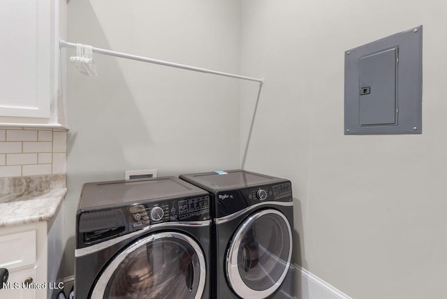 laundry area with cabinets, electric panel, and washing machine and clothes dryer