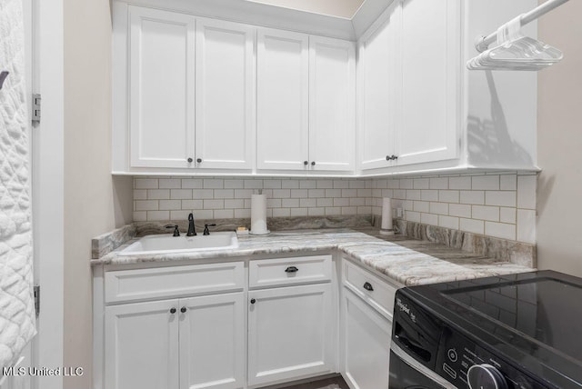 kitchen with white cabinetry and sink