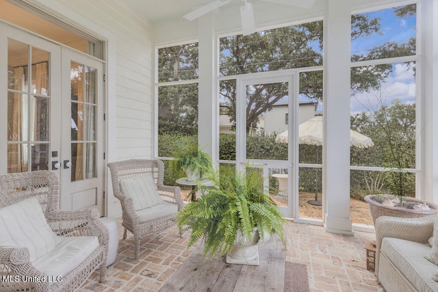 sunroom / solarium featuring french doors