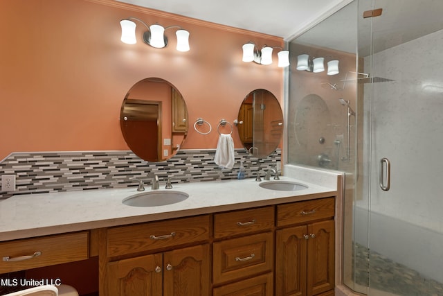 full bath with double vanity, a shower stall, backsplash, and a sink