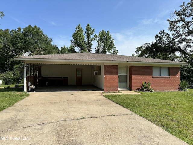 1628 Dry Creek Rd, Magee, MS 39111 - ranch-style house featuring driveway, a front lawn, brick siding, and a carport