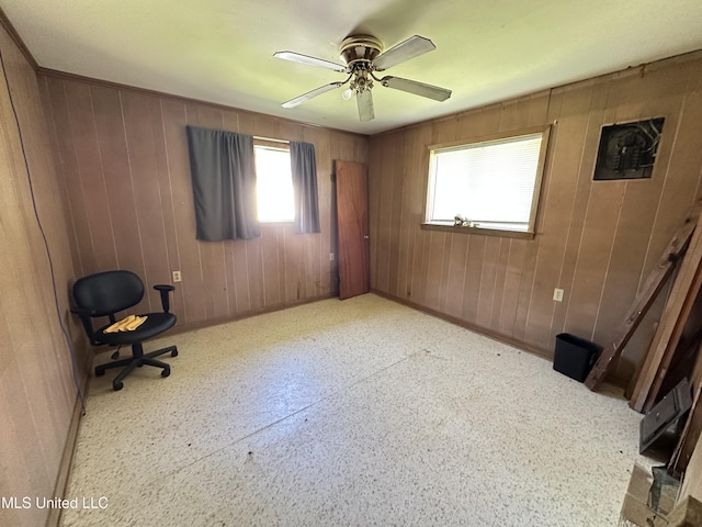 1628 Dry Creek Rd, Magee, MS 39111 - unfurnished office with baseboards, wooden walls, and a ceiling fan