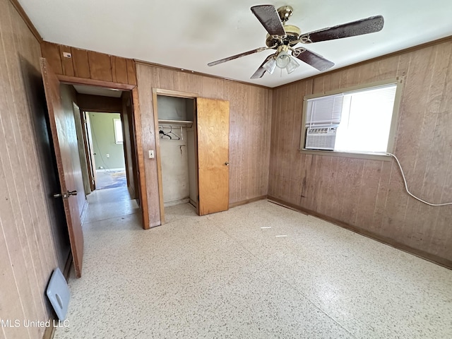 1628 Dry Creek Rd, Magee, MS 39111 - unfurnished bedroom featuring wooden walls, a closet, cooling unit, baseboards, and ceiling fan