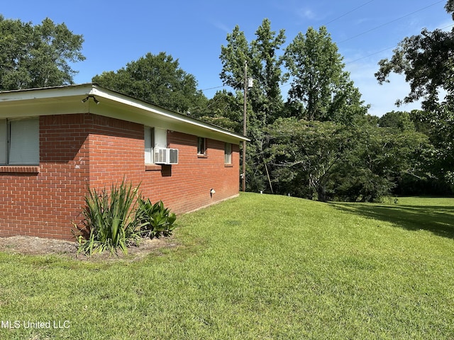 1628 Dry Creek Rd, Magee, MS 39111 - view of home's exterior featuring brick siding, a lawn, and cooling unit