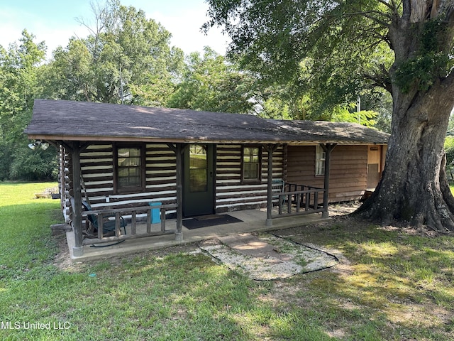 1628 Dry Creek Rd, Magee, MS 39111 - rear view of house with a lawn, log siding, and covered porch