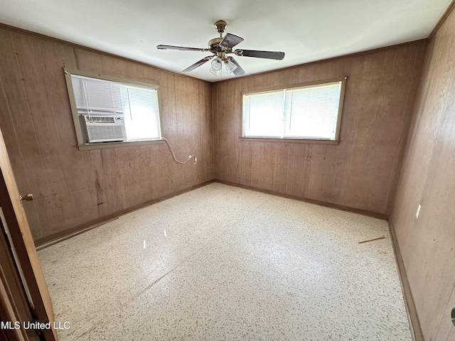 1628 Dry Creek Rd, Magee, MS 39111 - spare room featuring ceiling fan, wood walls, cooling unit, and baseboards