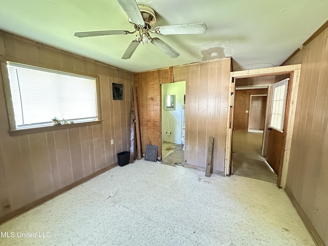 1628 Dry Creek Rd, Magee, MS 39111 - unfurnished bedroom with wooden walls, baseboards, a ceiling fan, and ensuite bathroom