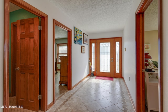 tiled foyer entrance featuring a textured ceiling