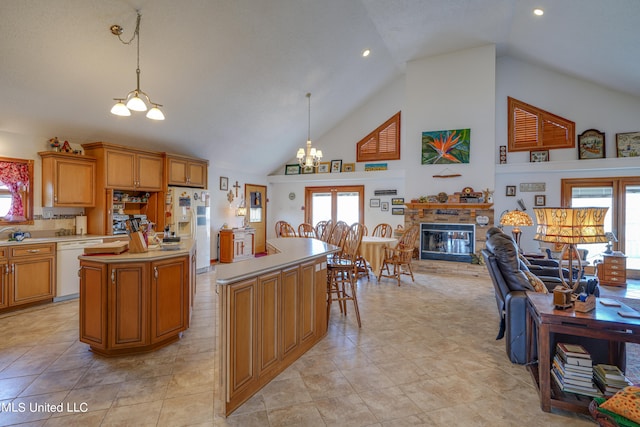 kitchen featuring a notable chandelier, a healthy amount of sunlight, pendant lighting, and a kitchen island